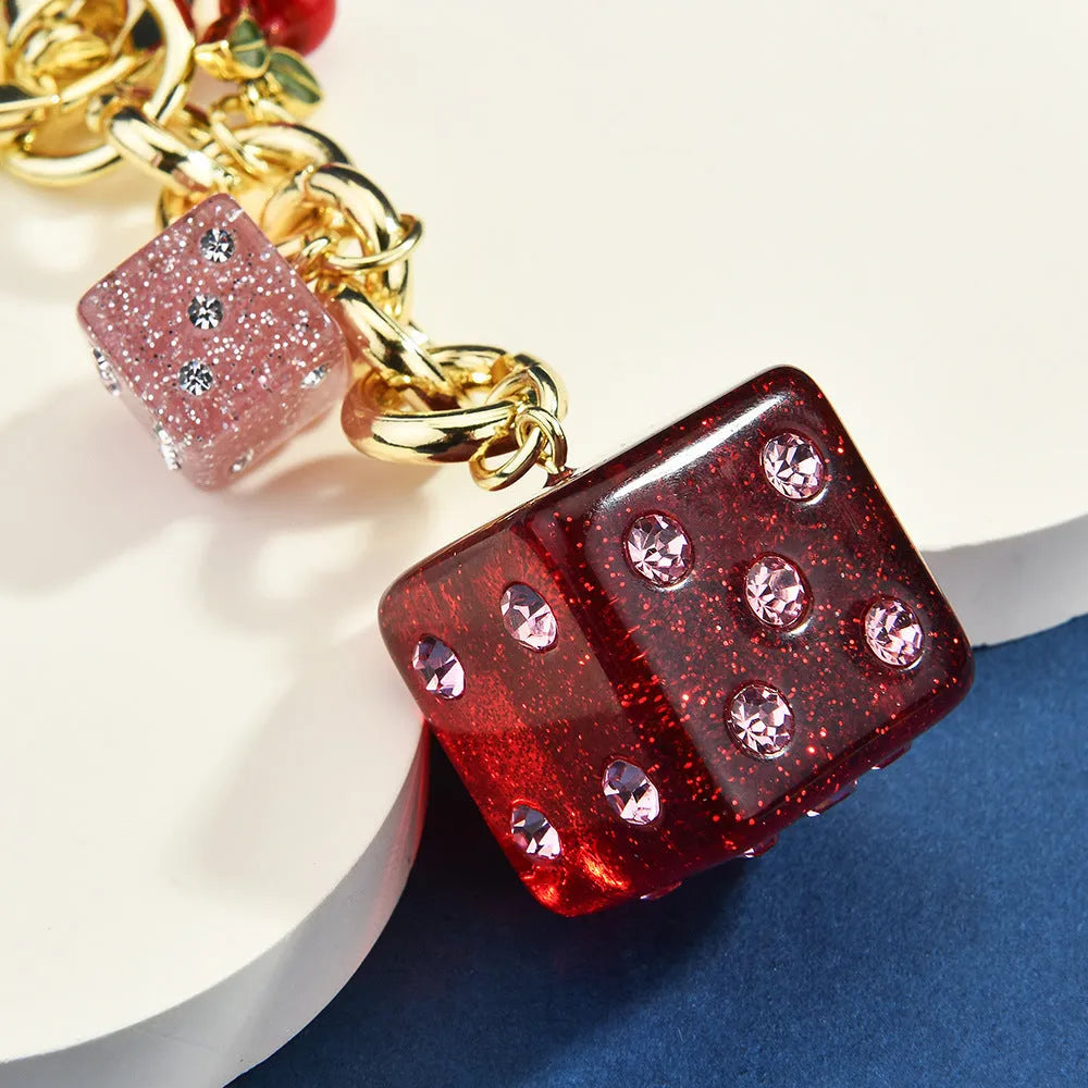 Square metal keychain pendant with a vintage cherry two-colour dice design.