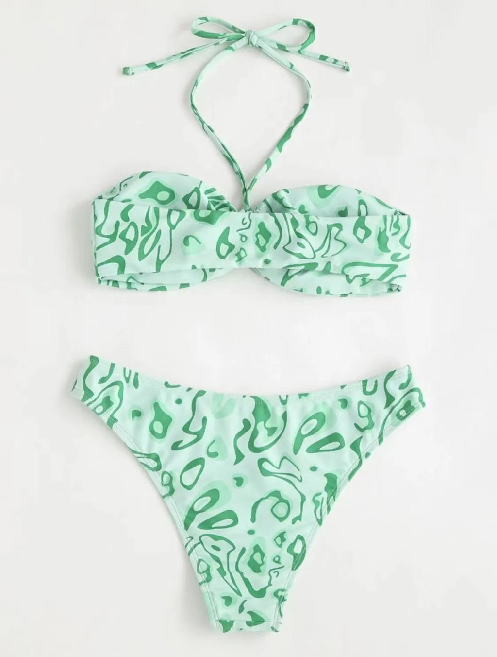 Women's blue floral bandeau bikini swimsuit with split design on beach background