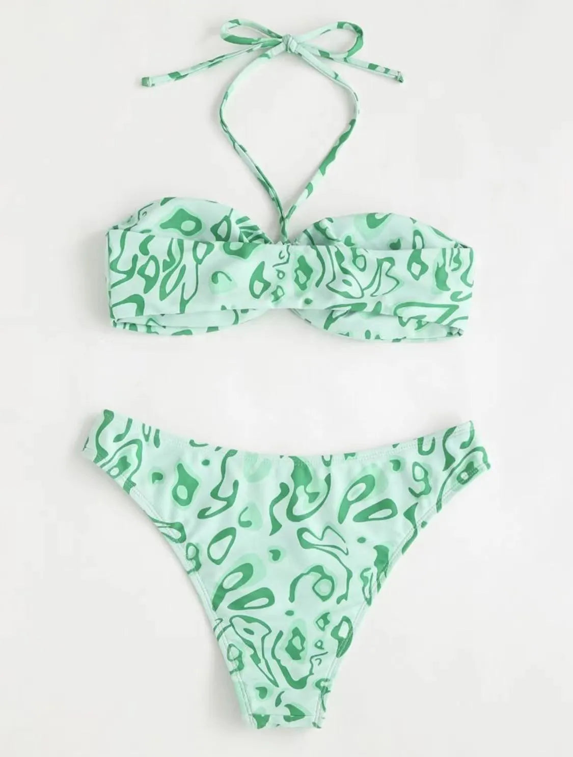 Women's blue floral bandeau bikini swimsuit with split design on beach background