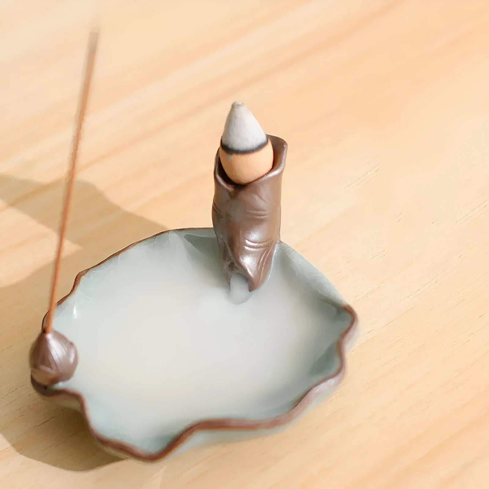 Purple clay ceramic reverse flow incense burner with lotus and plum blossom motifs