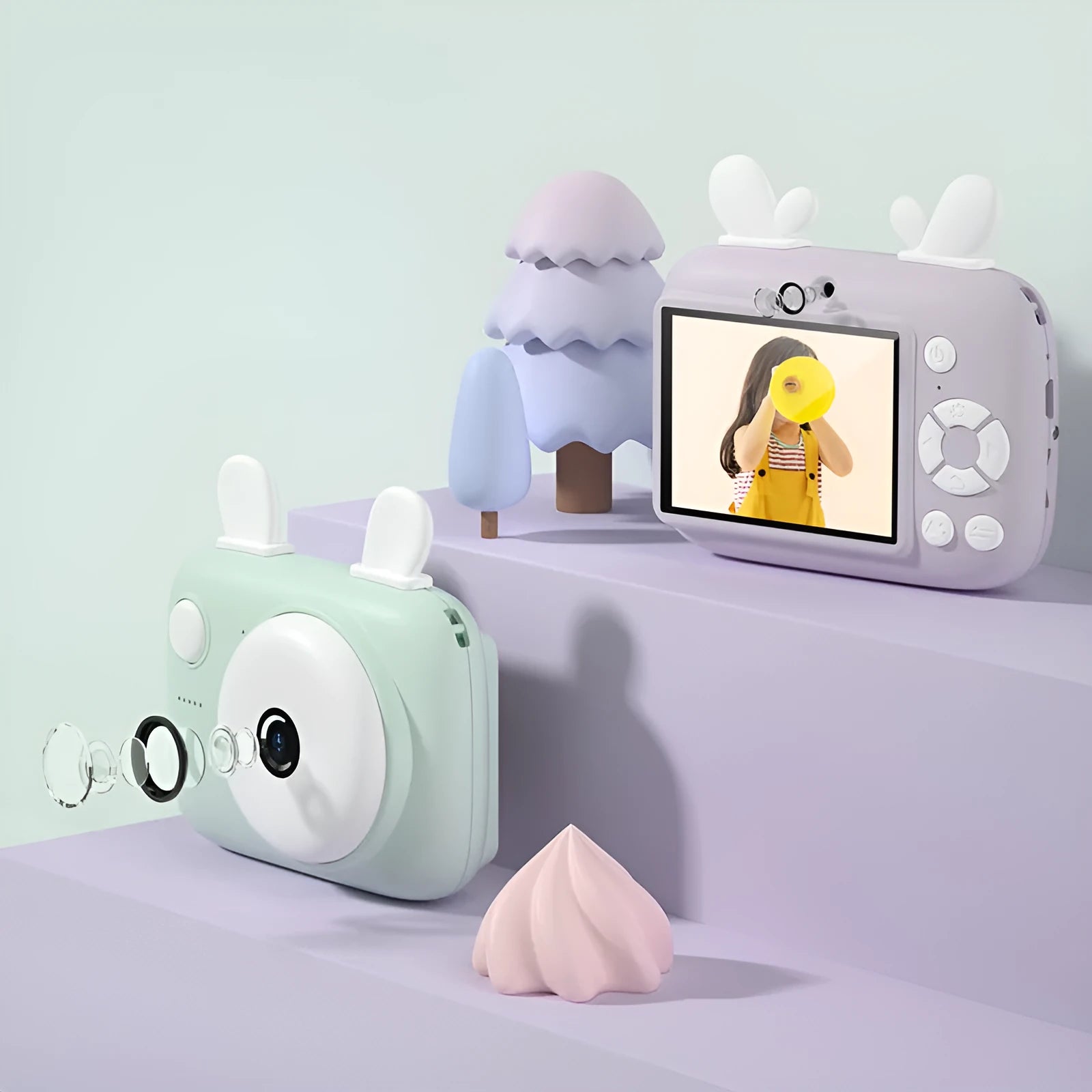 A2 Kids Macaron digital camera in green, showing front and rear lenses and 2.4-inch screen, with lanyard attached.