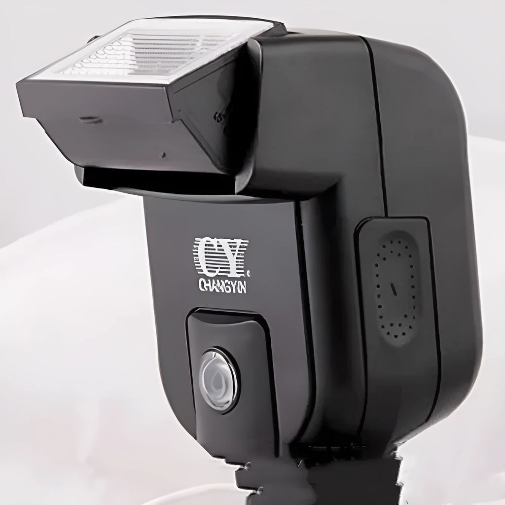 Compact black SLR camera flash with tilted head mounted on a DSLR camera hot shoe.