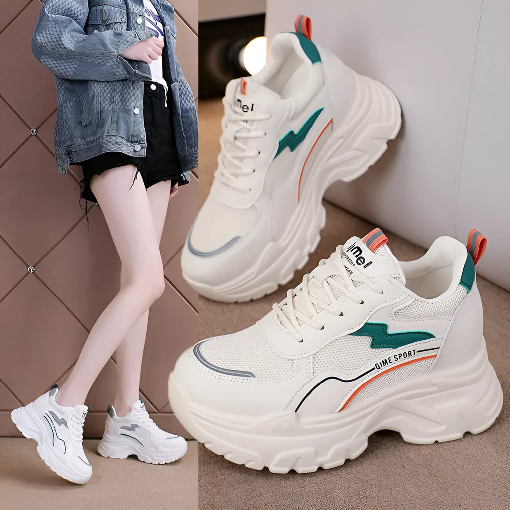 Women's white height increasing dad shoes with cross straps and lace-up front on rubber sole.