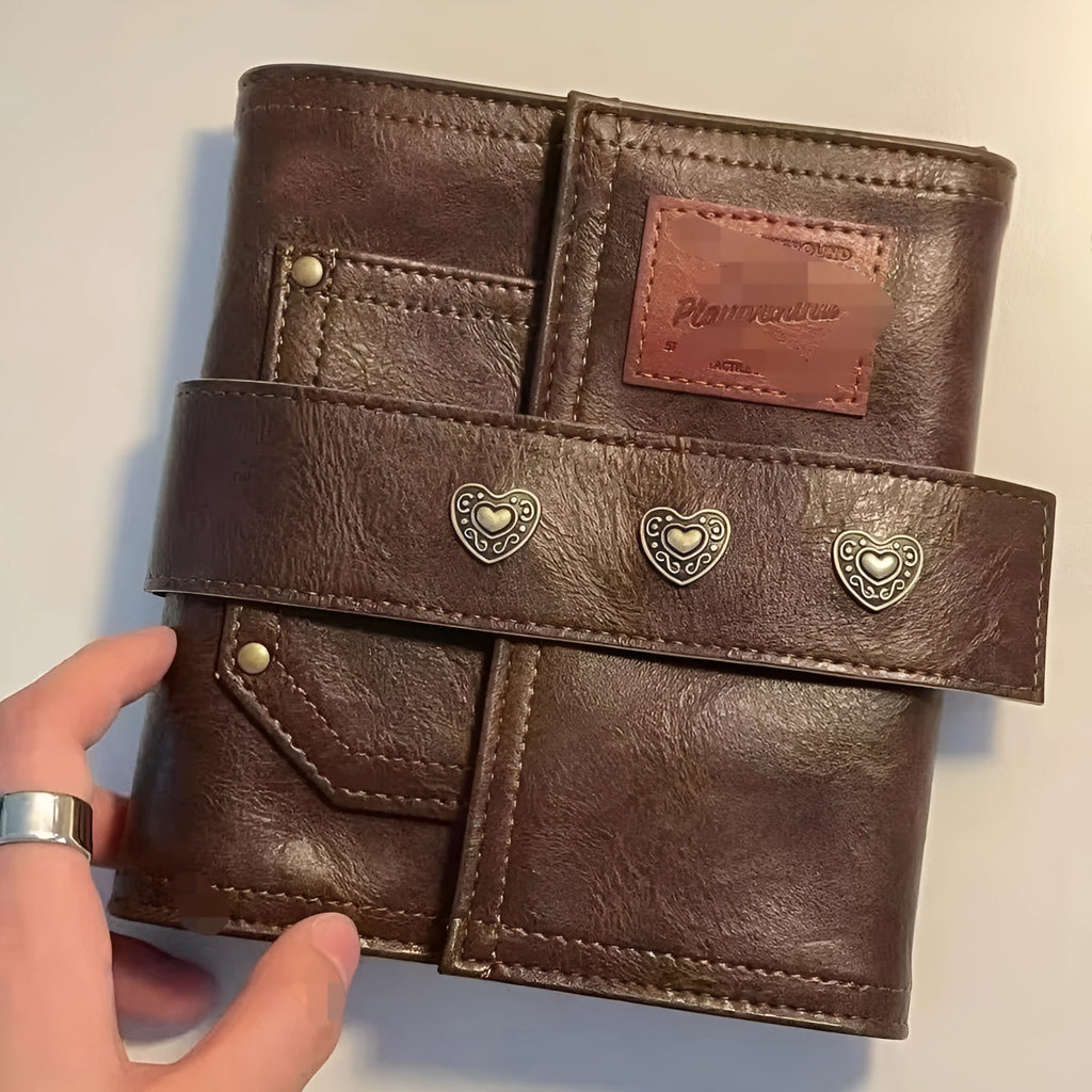 Brown retro-style notebook with leather buckle on PU cover, showing loose-leaf binder binding and A7 size