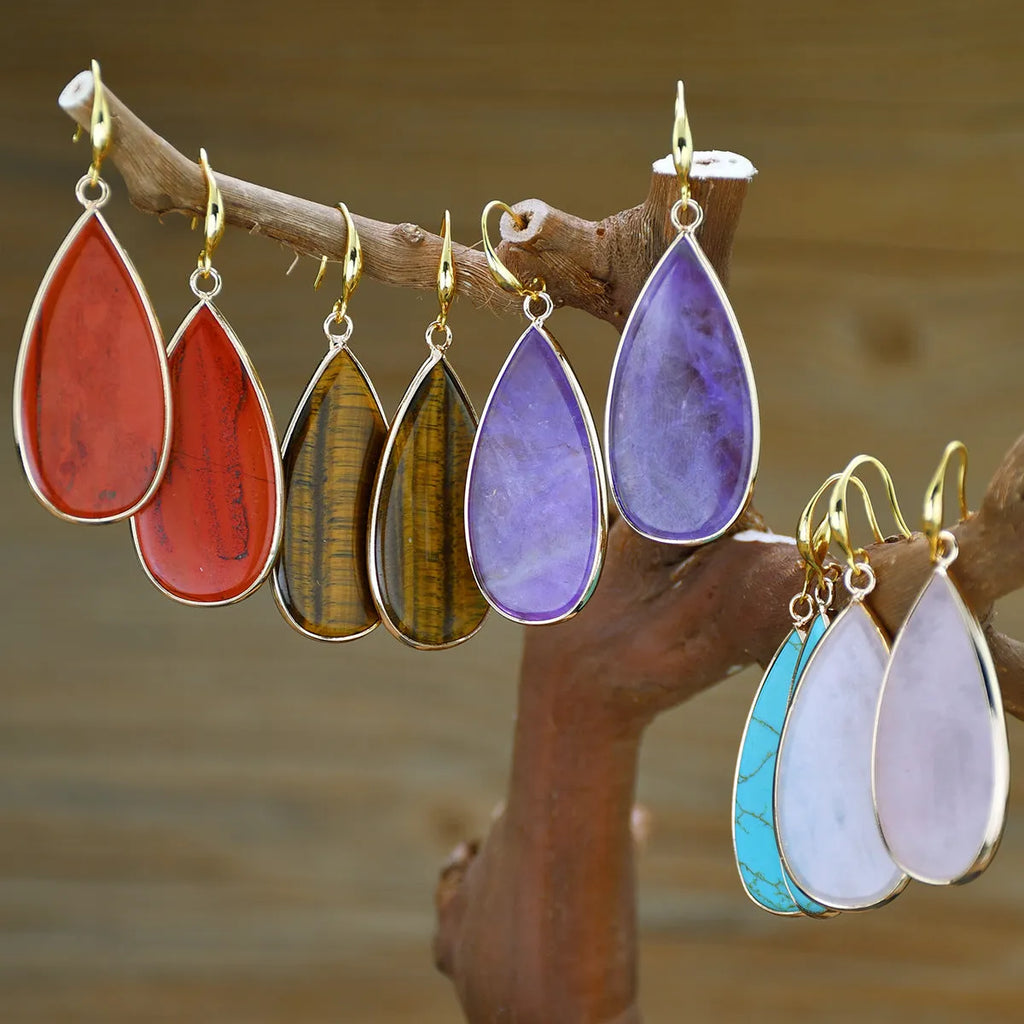 Vintage long drop earrings made from stone with a water droplet texture, shown in Tigereye colour.