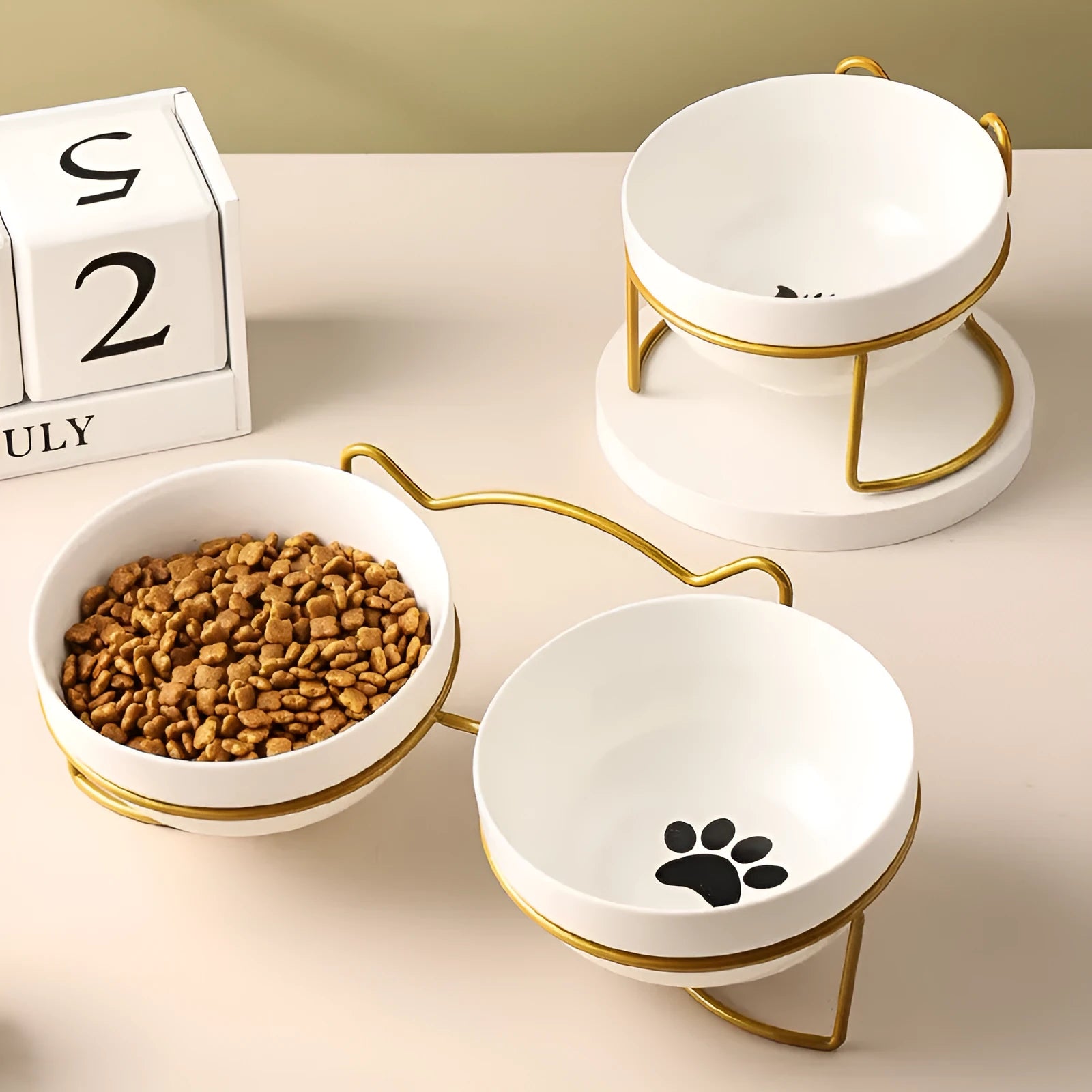 White ceramic cat bowl with cat paw design in black iron frame