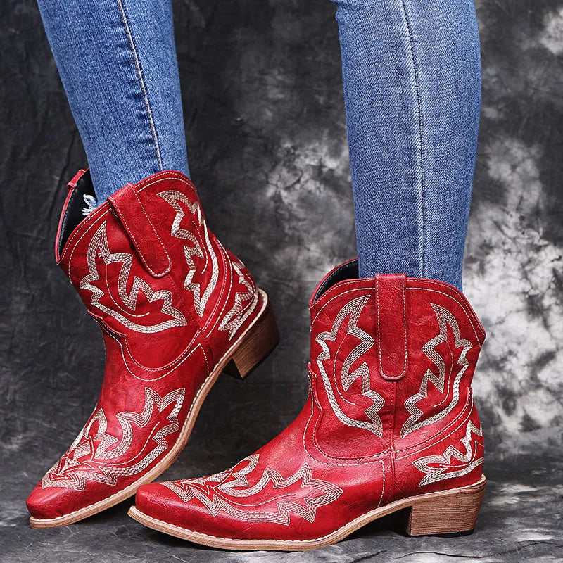Women's blue embroidered cowboy boots with low chunky heel and pointed toe.