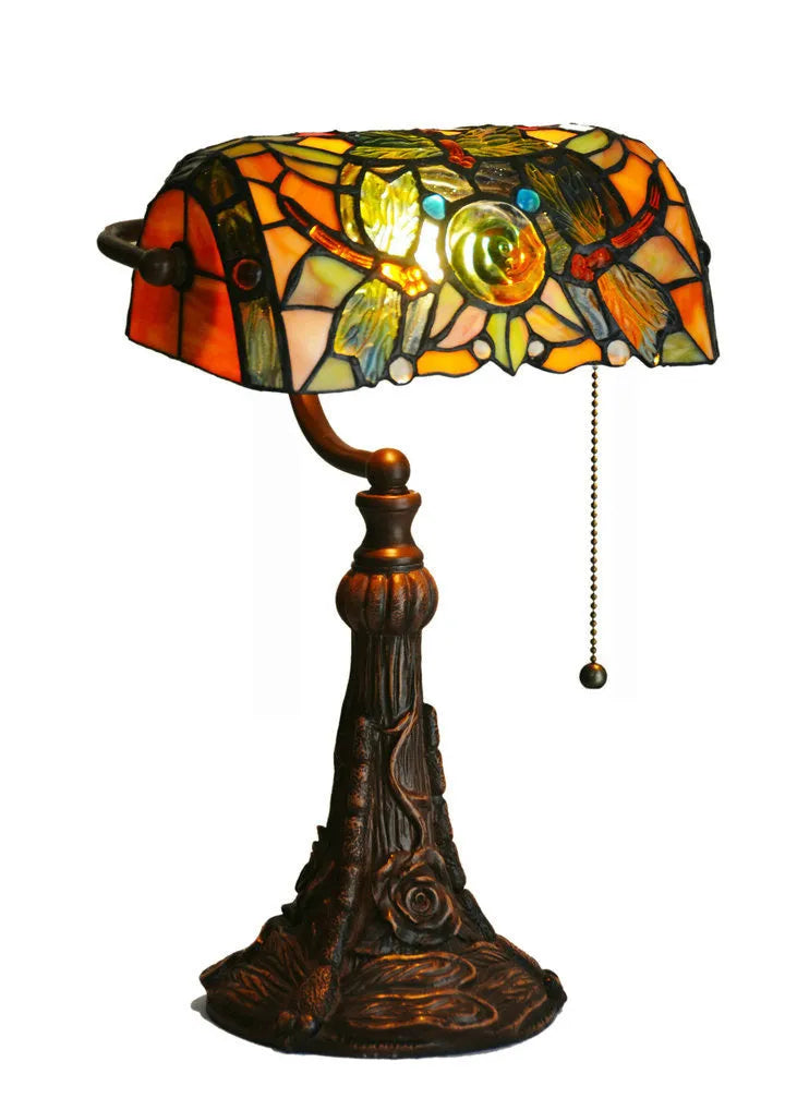 10-inch Tiffany style table lamp with coloured stained glass shade and resin base on a desk.
