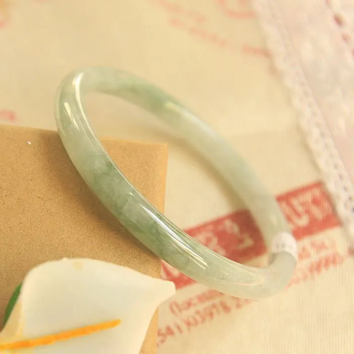 Green waxy jade geometric bracelet with Chinese-style design showing size measurement options