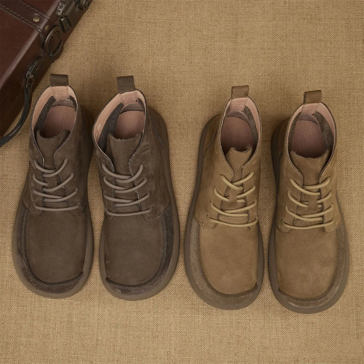 Grey genuine leather Martin boots with wedge heel and front lace-up design on a neutral background.