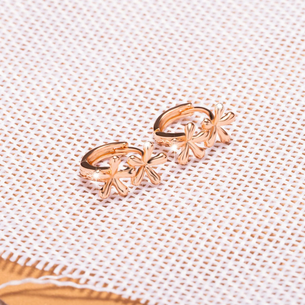 Rose gold coloured circular stud earrings with a detailed waterdrop floral design.