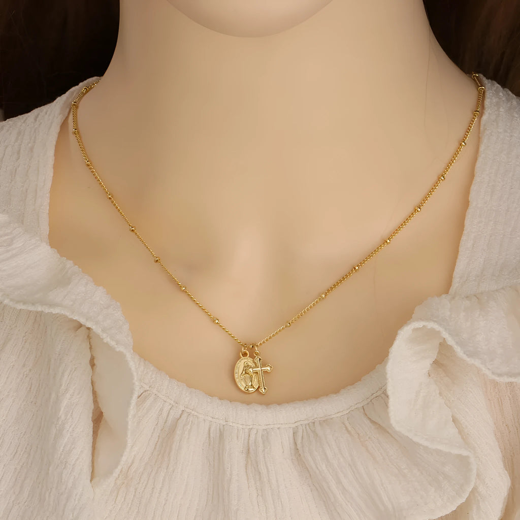 Gold geometric cross Virgin Mary necklace for women on a chain.