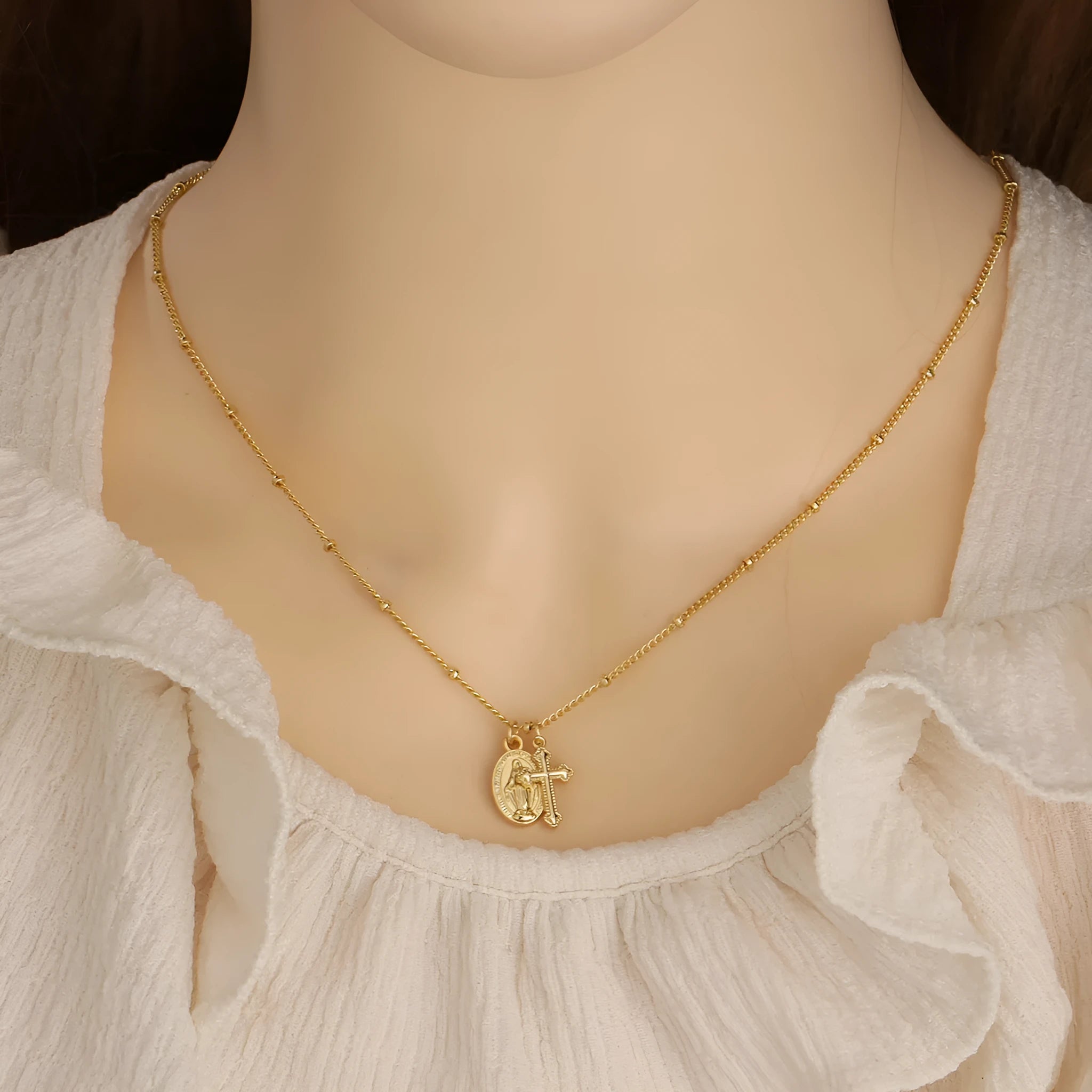 Gold geometric cross Virgin Mary necklace for women on a chain.