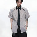 Men's blue and khaki patchwork striped shirt with diamond tie and quilted details, showing loose fit and flip collar.