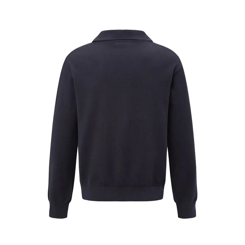 Man wearing a loose fit black pullover sweater for casual leisure wear.