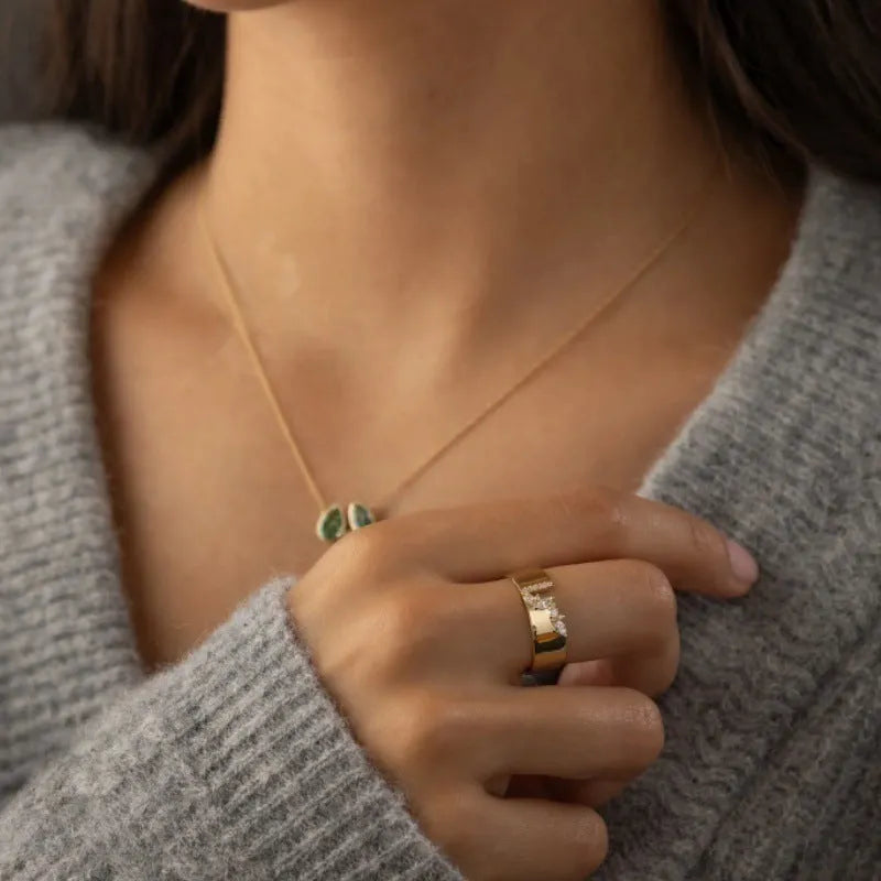 Gold-coloured electroplated copper band ring for women shown on a finger.