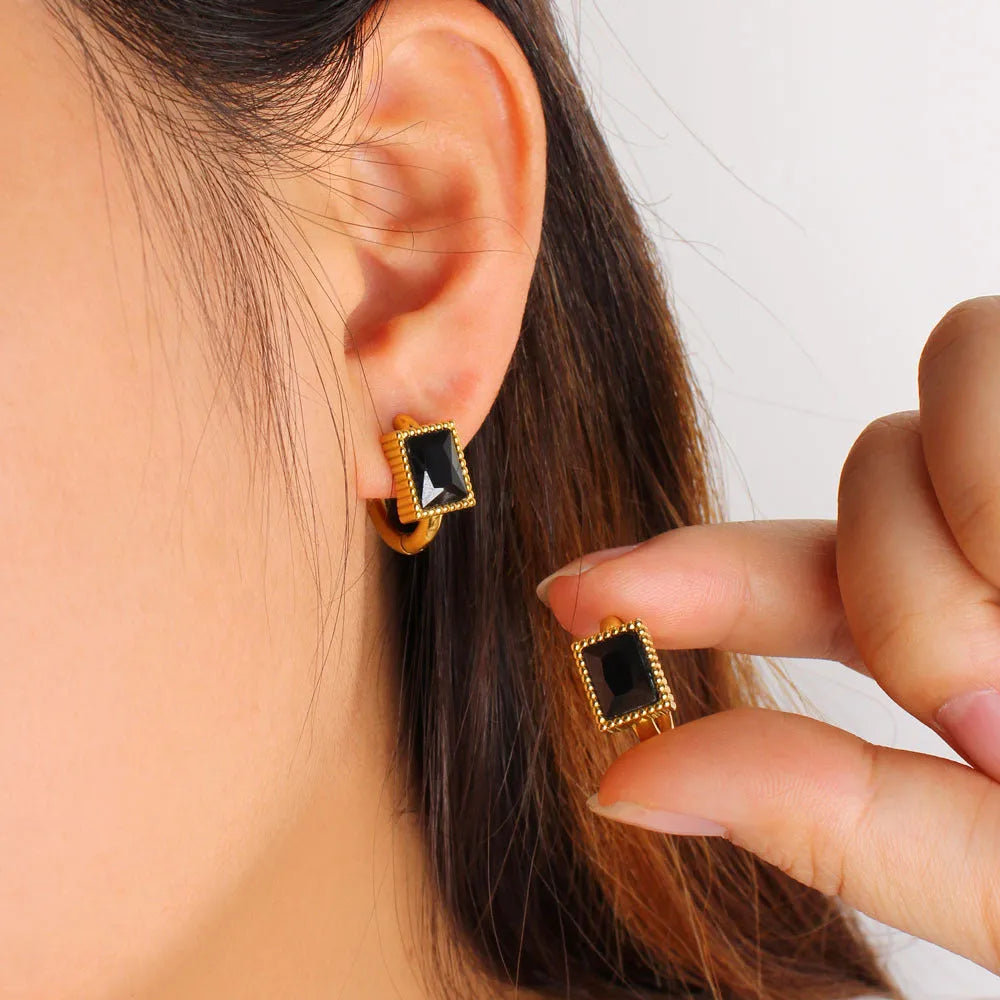 Geometric stainless steel earrings with square zircon stones and ring elements in electroplated colours
