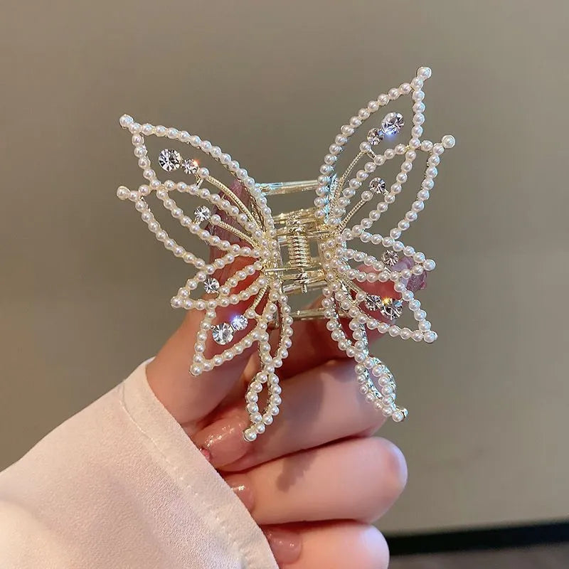 Butterfly-shaped alloy hair clip for women with electroplated finish, shown in rhinestone and pearl styles.