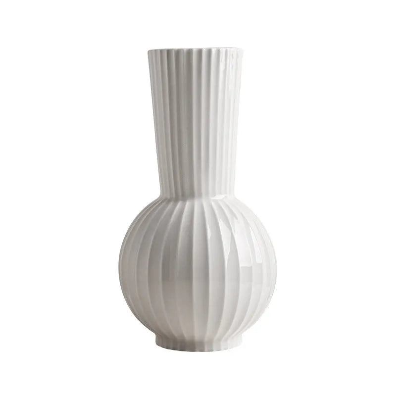 White ceramic ball-shaped vase with striped American country design on a table.