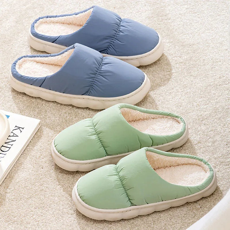 A pair of down cotton slippers with an artificial leather upper and thick rubber sole, shown in blue.