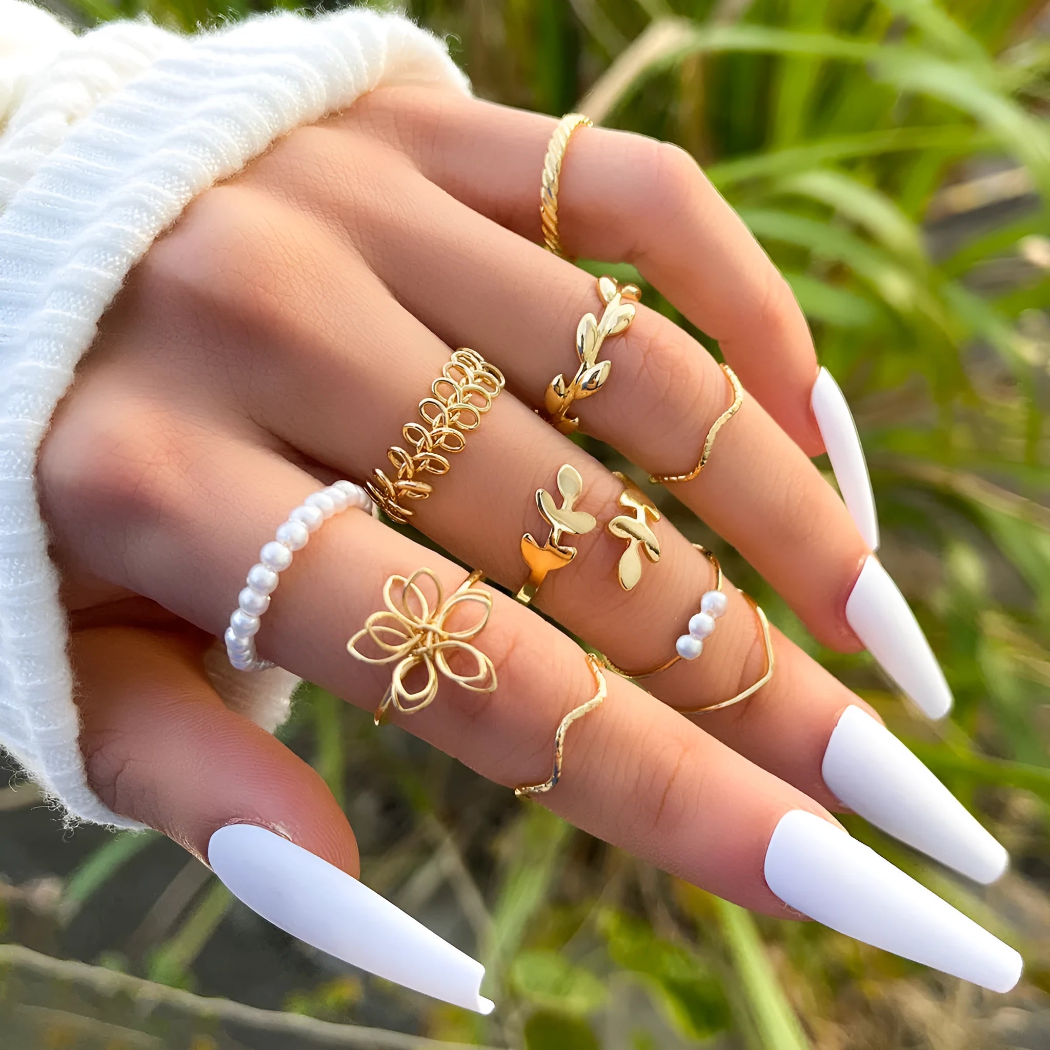 Gold tone openwork flower ring with intricate floral pattern design and glossy finish