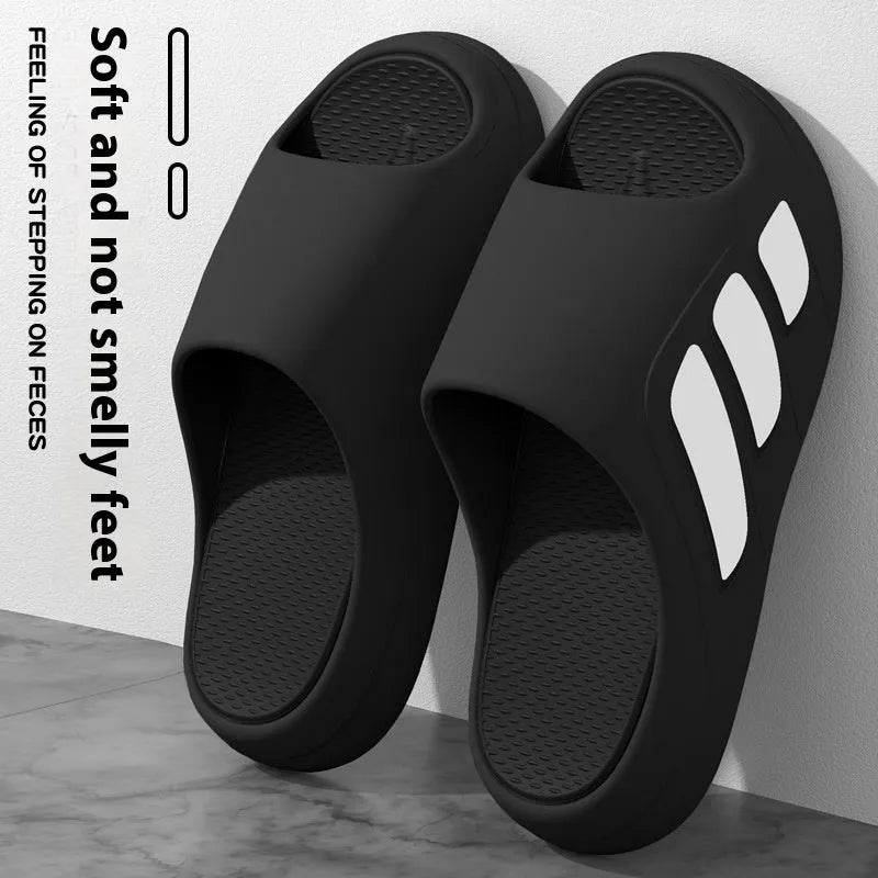 Pair of EVA platform slippers in a two-tone colour scheme, showing flip-flop style with letter detailing.