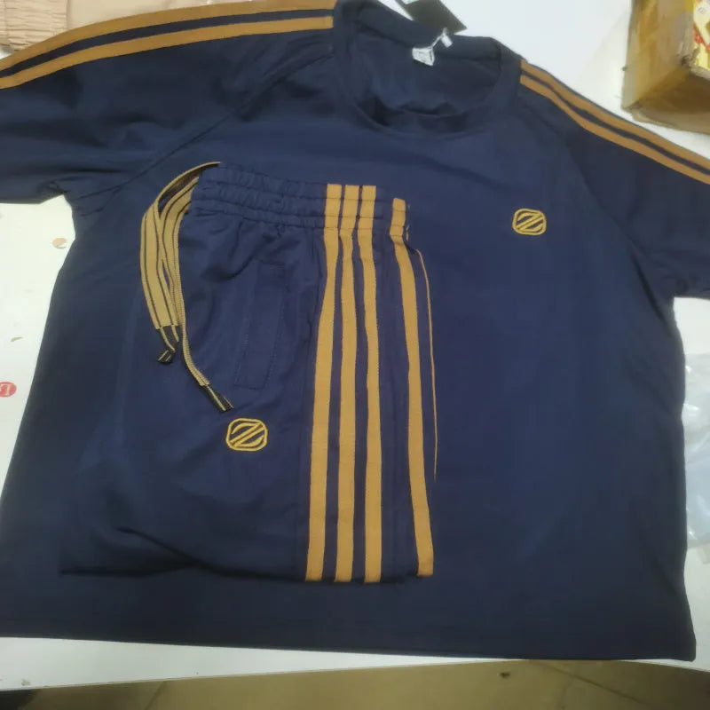 Men's blue polyester sports suit set with short sleeve top and matching trousers