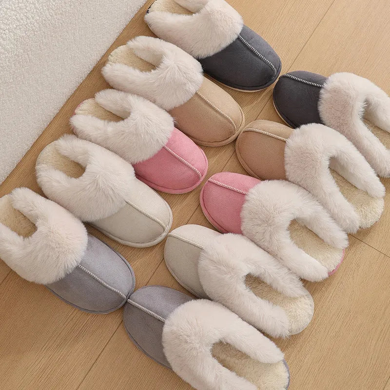 A pair of plush fur-lined indoor slippers with a round toe and a flat PVC sole.