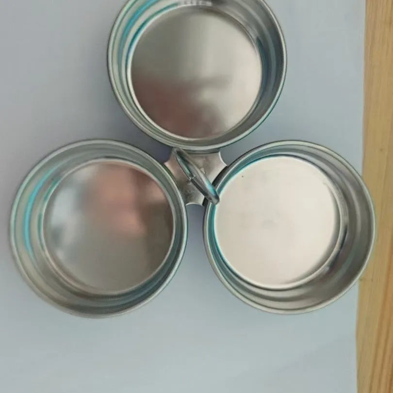 A mini stainless steel egg steamer shown in both round and heart-shaped design variations.