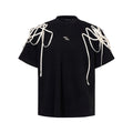 Black rivet ribbon padded shoulder short-sleeved T-shirt on hanger showing loose fit