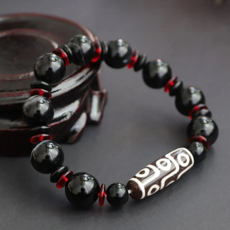 Black agate dzi bead bracelet with hand-woven construction and 11mm geometry beads