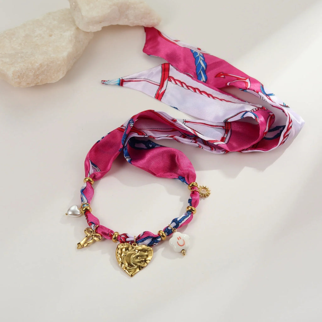 Stainless steel jewellery set with love pendant necklace and matching bracelet featuring geometric pendant designs
