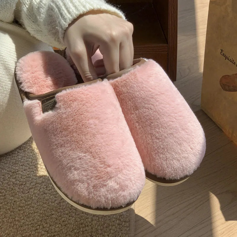 Solid-colour winter plush slippers with non-slip PVC sole on a home floor