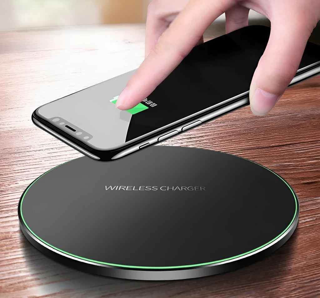 Black ultra-thin 9V QI wireless fast charger with USB cable on a desk.
