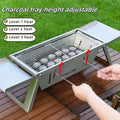 Small black foldable portable charcoal grill for outdoor barbecues, shown in both open and collapsed positions.