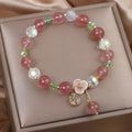 Women's double layer strawberry quartz bracelet with lucky cat charm in red cat's eye flowers colour.