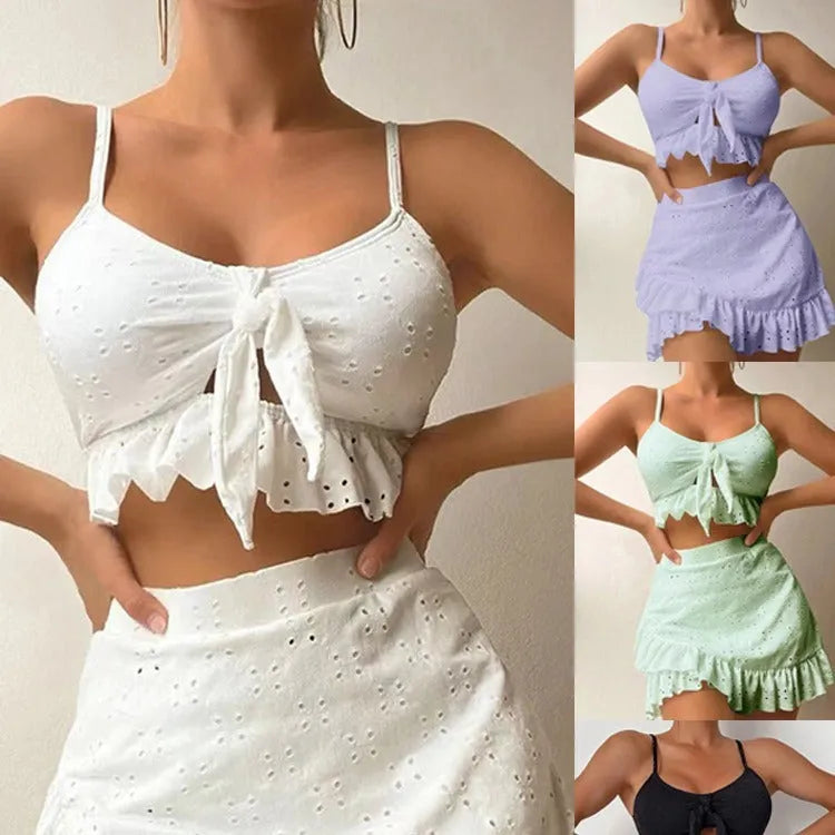 Women's solid colour three-piece bikini swimsuit with a split hip skirt.