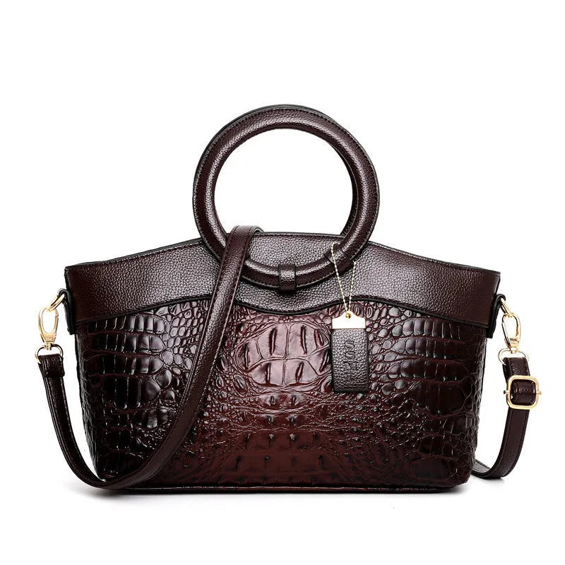 Brown fabric women's handbag showing front zipper compartment and internal organiser pockets.