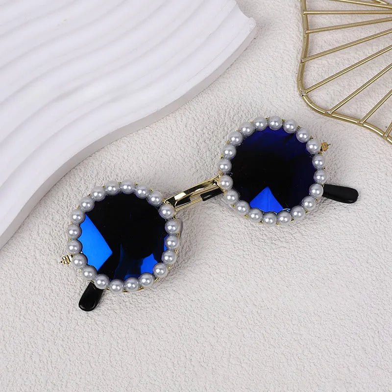 Pearl-rimmed round sunglasses on a cat and dog for costume dress up