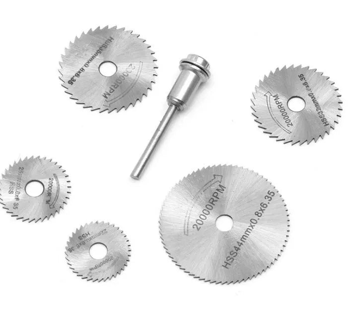 Set of six high-speed steel circular saw blades and a mandrel on a grey background.