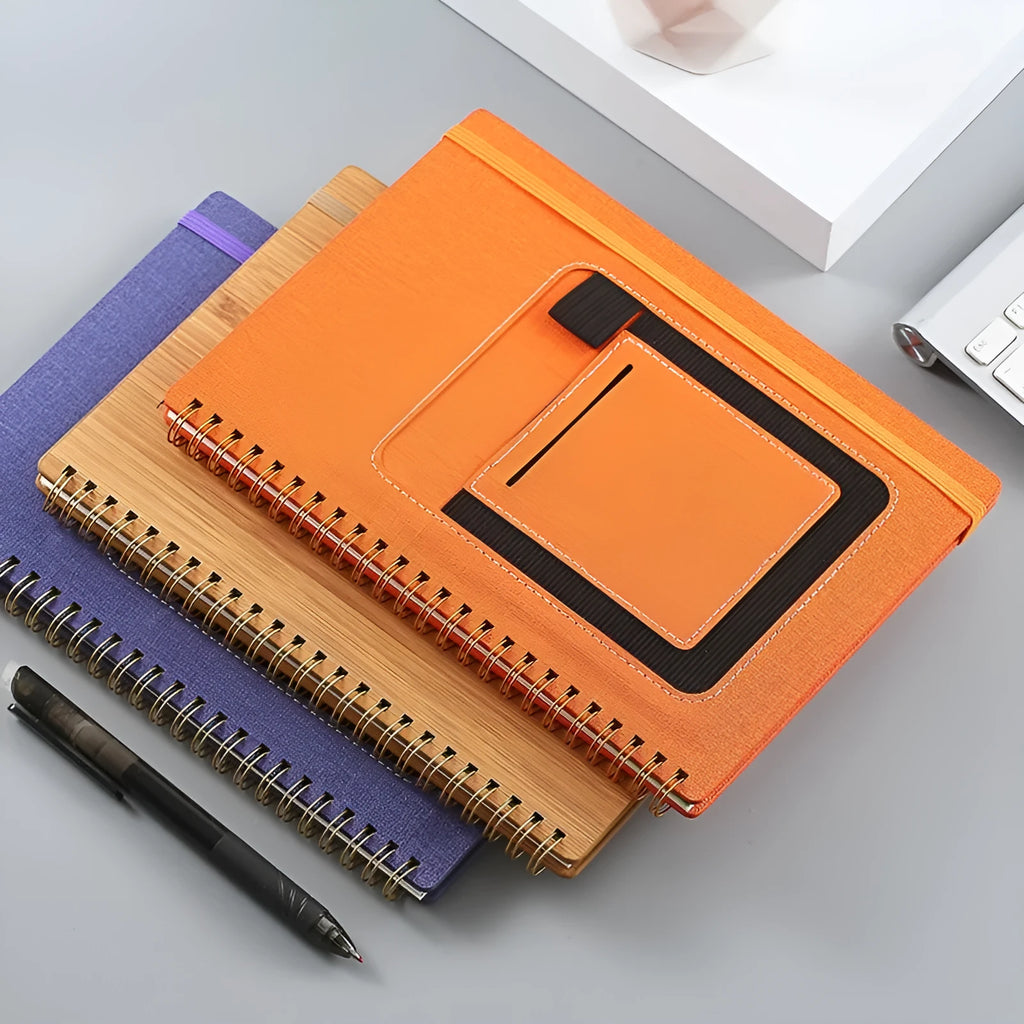 A5 erasable coil notebook with stone paper, open to show reusable pages and included pen, with custom cover options displayed.
