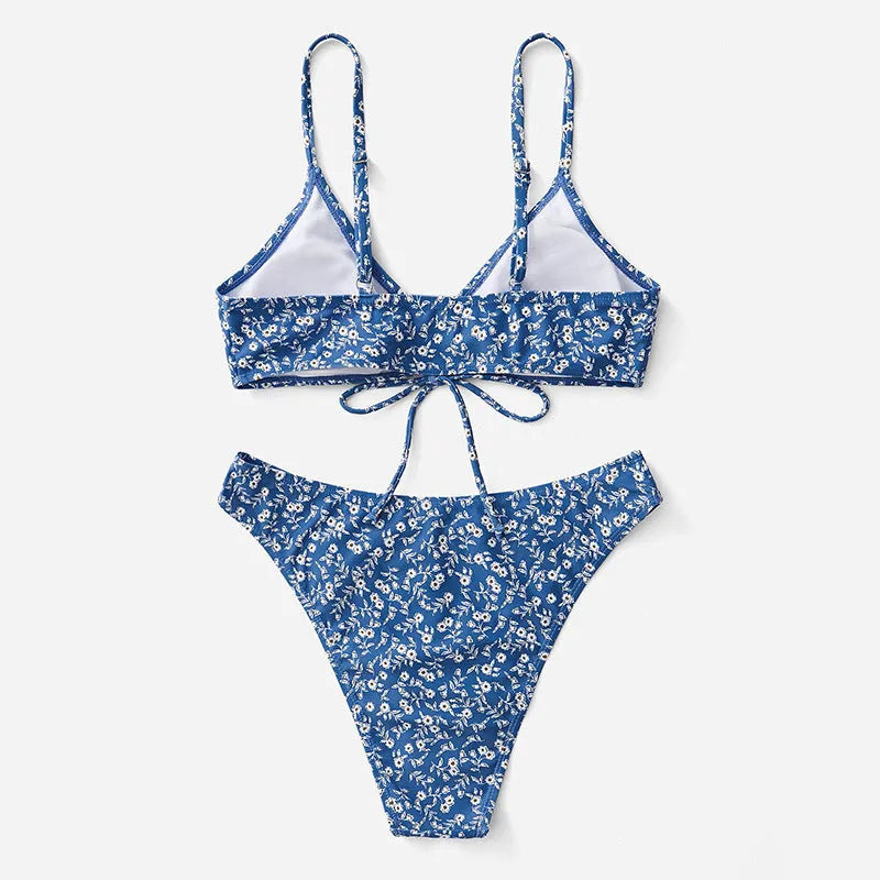 Blue women's three-piece swimsuit set with separate top and shorts on a white background.