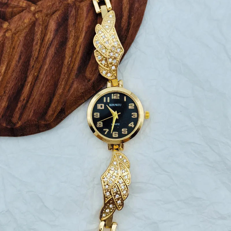 Stainless steel women's watch with round dial on wrist showing gold surface colour