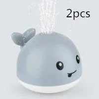 Electric whale bath toy spraying water with flashing LED lights in baby bath