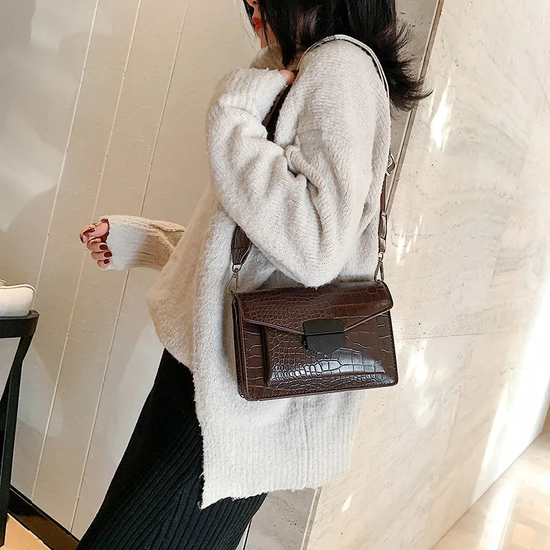Vintage-style crossbody bag in PU leather shown in black, dark brown, khaki, or red