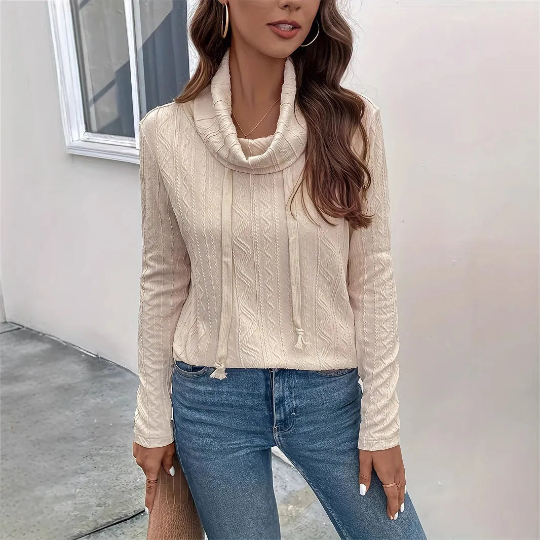 Apricot coloured long sleeve hooded pullover sweater with a drawstring hood on a hanger.