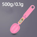 Black electronic digital measuring spoon scale on a kitchen worktop showing weight display.