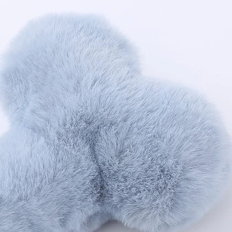 Blue plush bone-shaped dog toy with a squeaker, labelled Grinding Teeth, on a plain background