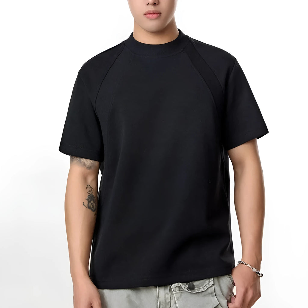 Man wearing a loose-fit black short-sleeve polyester top with air layer stitching.