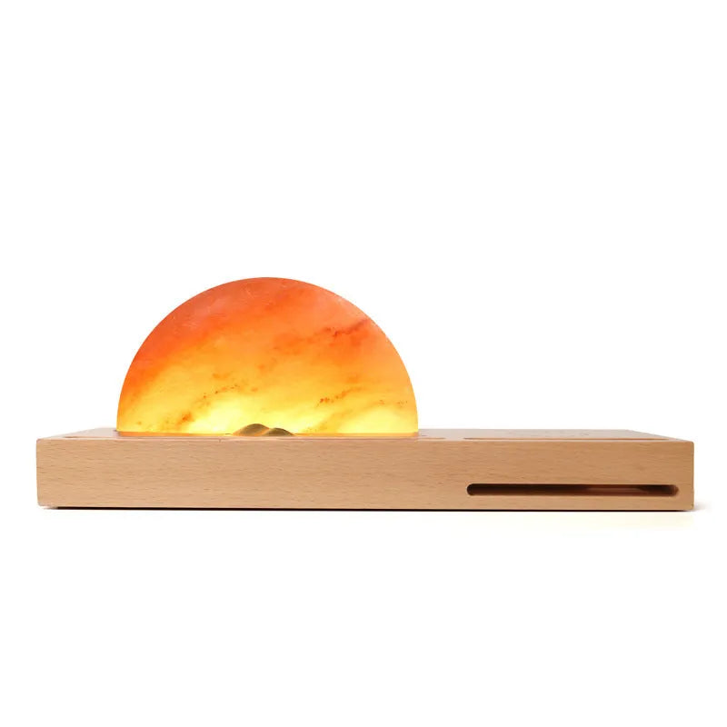 Sunrise Oriental table lamp with natural salt shade on wood base, showing wireless phone charging.